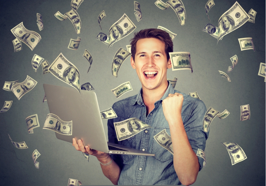 A happy man making money online in dollars.